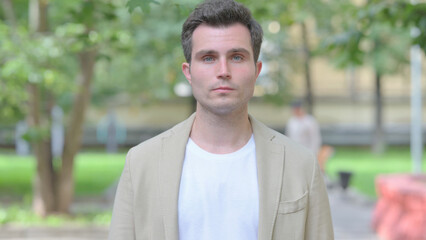 Outdoor Portrait of Serious Casual Young Man