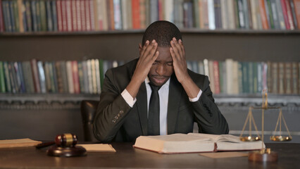 Tense African Male Lawyer with Headache in Office