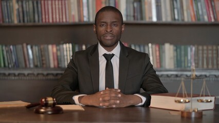 Serious African Male Lawyer Sitting in Office
