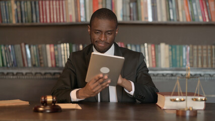 African Male Lawyer using Tablet in Office