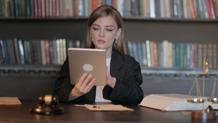 Young Female Lawyer using Tablet in Office