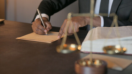 Fototapeta na wymiar African Judge Writing Verdict in Court, Close Up
