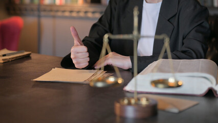 Fototapeta na wymiar Close Up of Thumbs Up by Female Judge in Court