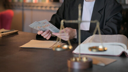 Fototapeta na wymiar Close up of Female Lawyer Counting Money