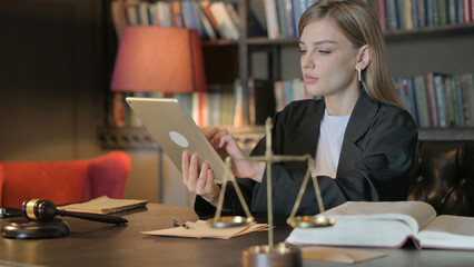 Obraz na płótnie Canvas Female Lawyer using Tablet in Office
