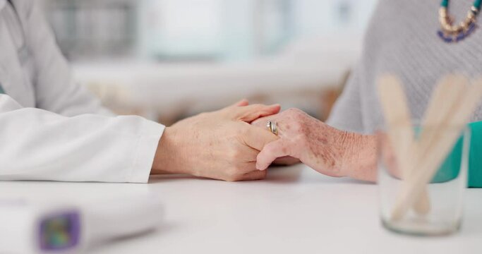 Senior woman, doctor and holding hands with patient in elderly care, love or consultation at the hospital. Closeup of medical professional touching hand for healthcare trust, support or appointment