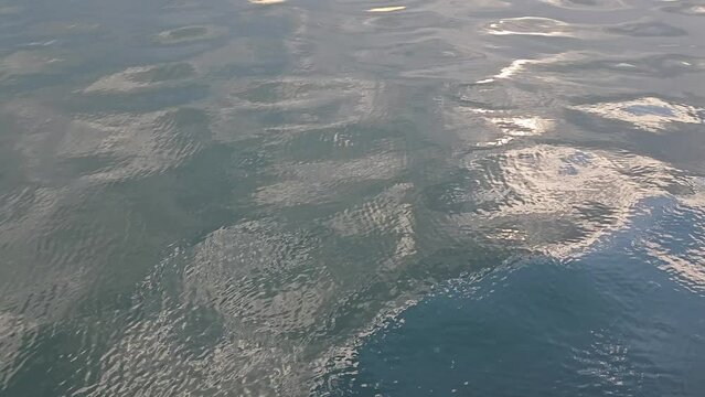 Sea water ripples surface with sunlight reflection, beautiful natural background 
