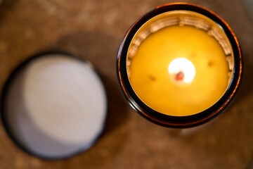 candle on a table with yellow flame