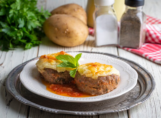 Turkish Food Hasanpasa Kofte - Kofta with Puree - Meatball with Bechamel Sauce and Green Peas. Traditional Food.