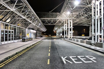 Deserted drop off point of an airport at night