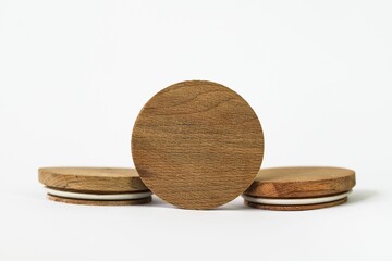 Round bamboo lids of jar arranged on top of a white background with copy space
