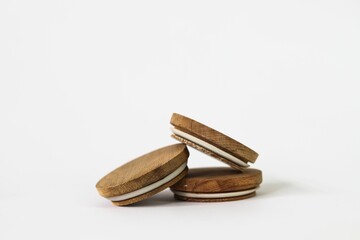 Round bamboo lids of jar arranged on top of a white background with copy space-balance concept