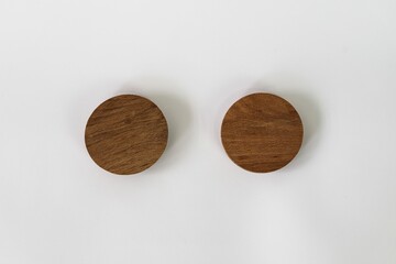 Bamboo lids of jar arranged on top of a white background with copy space