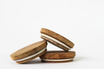 Round bamboo lids of jar arranged on top of a white background with copy space-balance concept