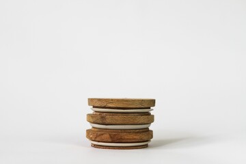 Round bamboo lids of jar arranged on top of a white background with copy space-balance concept
