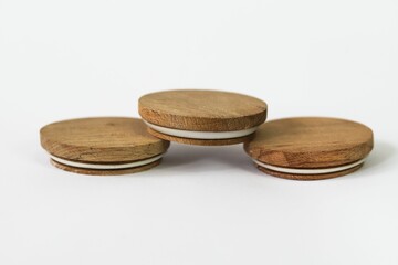 Round bamboo lids of jar arranged on top of a white background with copy space