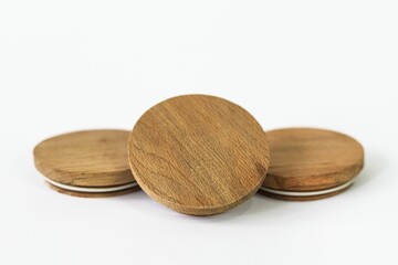 Round bamboo lids of jar arranged on top of a white background with copy space