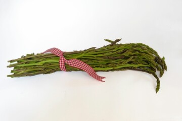 Closeup of a bunch of fresh green asparagus spears on a white background