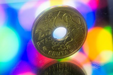 Closeup of 25 Spanish Pesetas coin on a bokeh background