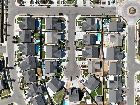 aerial view of a suburban residential area with a paved street