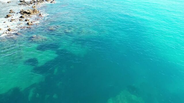 Drone shot of Antibes town with Chateau Grimaldi castle along sea on a sunny day