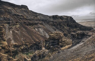 Shot of an natural landscape featuring large rocks, with a cloudy sky in the background