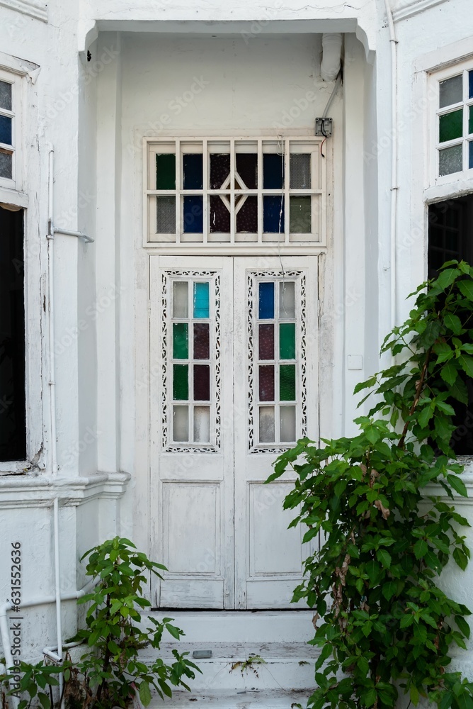 Wall mural Vertical shot of a white  modern doorway illuminated by natural light