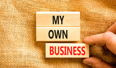 My own business symbol. Concept words My own business on wooden block. Beautiful canvas table canvas background. Businessman hand. Business motivational my own business concept. Copy space.