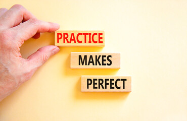 Practice makes perfect symbol. Concept words Practice makes perfect on wooden block. Beautiful white table white background. Businessman hand. Business practice makes perfect concept. Copy space.