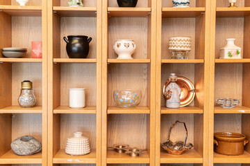 Sweden, Malmo – July 8, 2023: European vintage second hand with many beautiful unusual things, porcelain, bijouterie, jewelery. Flea market, garage sale.