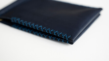 Details of empty blue men's money clip handmade leather wallet.