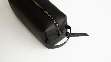 Man's black leather personal cosmetic bag or pouch for toiletry accessory. Style, retro, fashion, vintage and elegance.