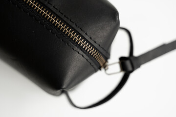 Close up, details of man's black leather personal cosmetic bag or pouch for toiletry accessory. Style, retro, fashion, vintage and elegance.