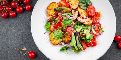 baked potato salad vegetable potato, tomato, onion, salad leaves, salad dressing vinaigrette vegetables food healthy meal food snack on the table copy space food background rustic top view 