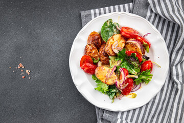 baked potato salad vegetable potato, tomato, onion, salad leaves, salad dressing vinaigrette vegetables food healthy meal food snack on the table copy space food background rustic top view 