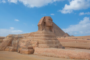 The Sphinx of Giza next to the Pyramids in the desert, Egypt in Asia - obrazy, fototapety, plakaty