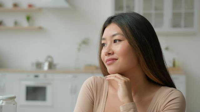 Asian Korean Dreamy Ethnic Woman Calm Girl Japanese Chinese Lady Housewife Wife Female Homeowner Dreaming In Home Kitchen Relaxed Peaceful Looking In Side Thinking Future Plans Dream Imagination Smile