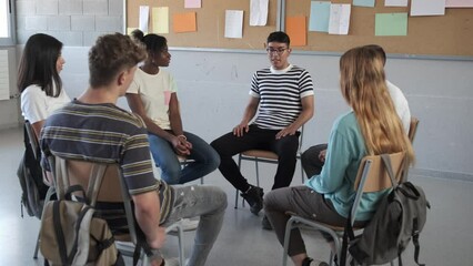 Latino student receives praise from classmates. Multiracial group of high school students clapping celebrate.Video 4k