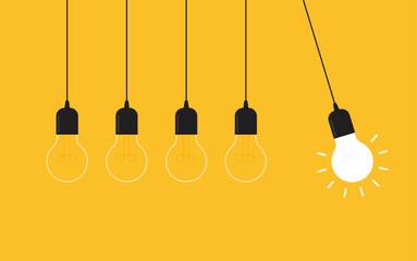 Hanging light bulbs with one glowing on yellow background. Concept of idea