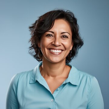 Portrait of a Middle Aged Hispanic Woman Headshot on a Blue Background 