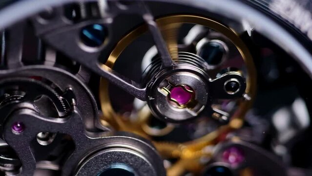 Mechanical watches with gears and cogs. Watch or clock mechanism. Mechanical skeleton watch. Clockwork details and parts.Clock gears running with dramatic flickering light.Open balance extreme closeup