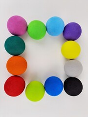 Colorful balls levitating in studio set square shape