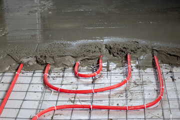 Installation of polypropylene pipes for underfloor heating systems, pouring the floor with concrete
