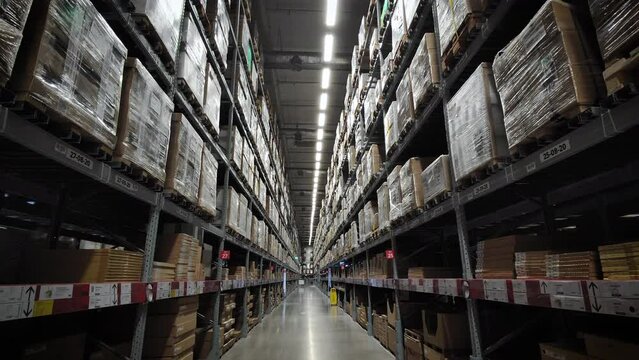 large warehouse of furniture department stores. A warehouse where goods are stacked in record steel frames for replenishing stock of products sold to customers.