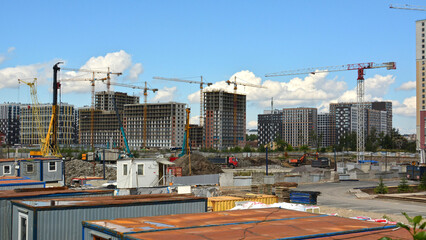 Construction site and construction city near the development of new residential buildings: building...