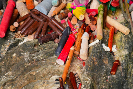 Wooden sculptures of phalluses of different colors in the Princess Cave, a buddhist temple on Phra Nang Cave Beach on the Railay Peninsula in the Province of Krabi, Thailand