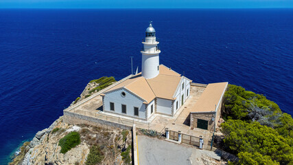 Fototapeta na wymiar Capdepera lighthouse on the easternmost point of Majorca in the Balearic Islands, Spain - Rocky cape with a navigational beacon in the Mediterranean Sea
