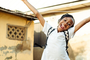 A little girl with her arms in the air