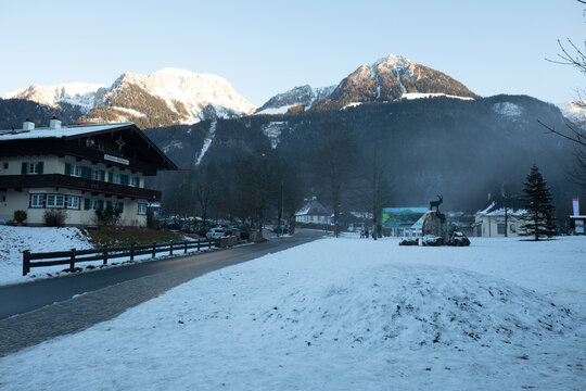 Sch&ouml;nau am K&ouml;nigssee, Germany, January 1st 2020 - Taken during winter. Photo of typical German architecture in mountain areas. Snow on ground. Overall scene is dark and misty.