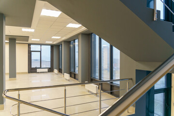 Stairwell in a modern building. An empty spacious hall with a flight of stairs in the business...